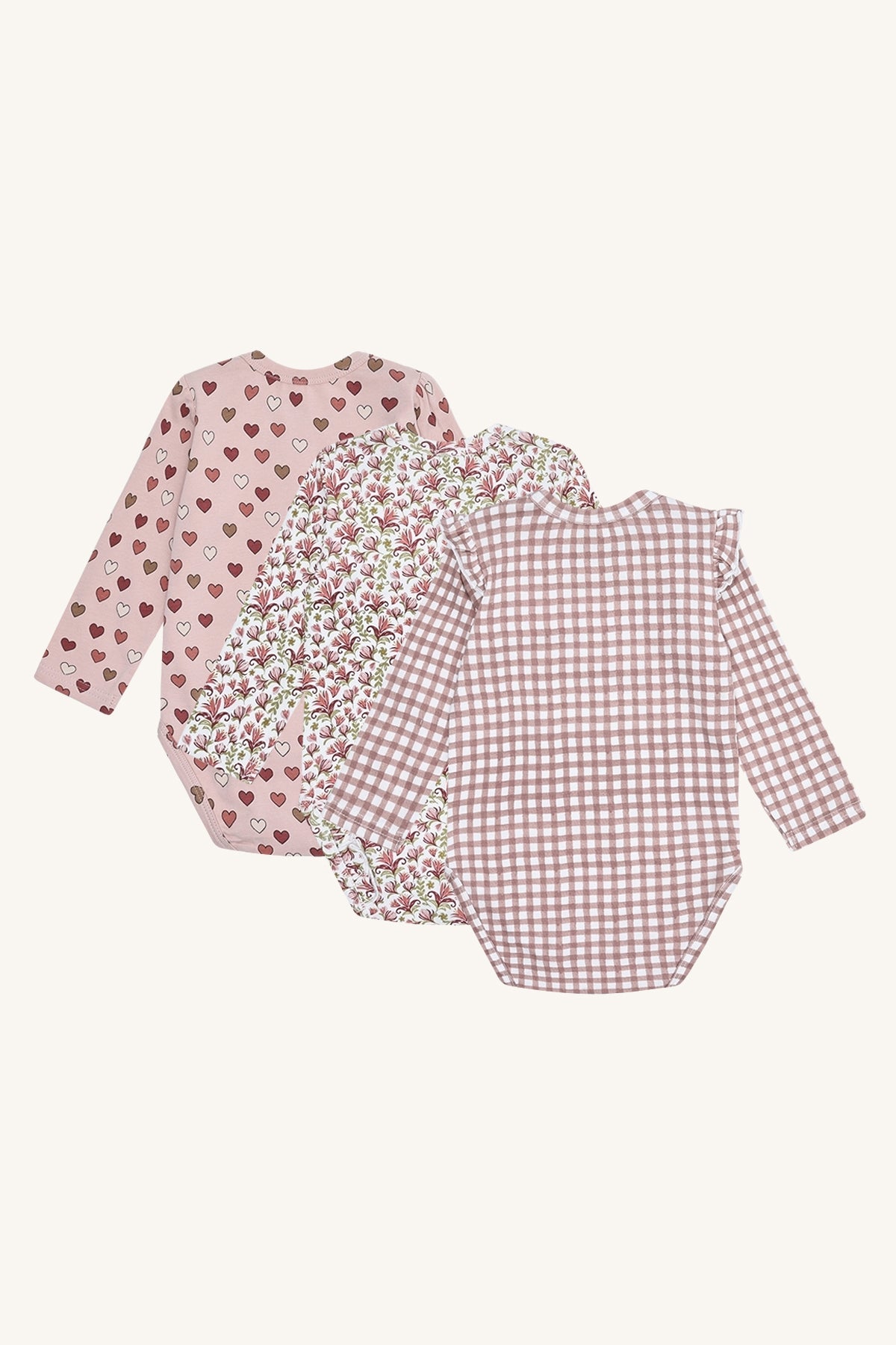 Rückansicht der drei Hust & Claire Bella Langarmbodies in Adobe Rose mit unterschiedlichen Mustern.