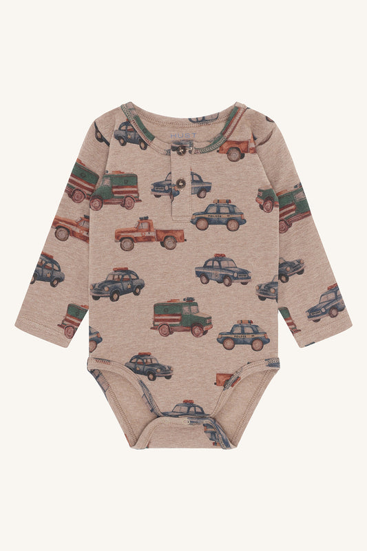 Babybody Billy von Hust&Claire in Biscuit mit Polizeiauto-Motiv aus Bio-Baumwolle, erhältlich im Bärechind Winterthur, Zürich Schweiz