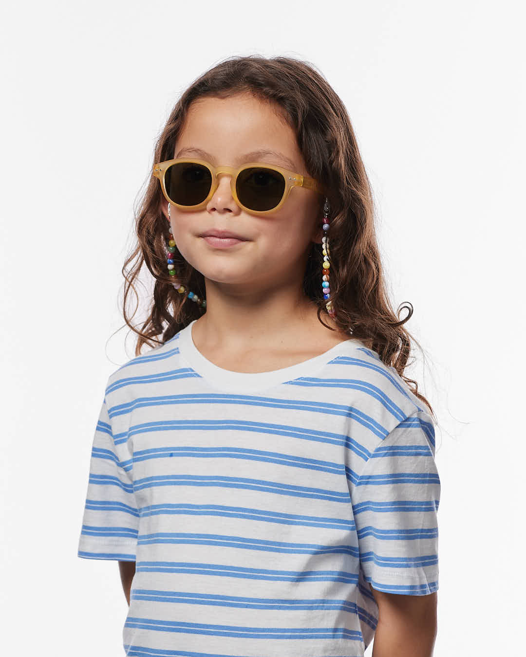Kind trägt die IZIPIZI Kindersonnenbrille in Yellow Honey