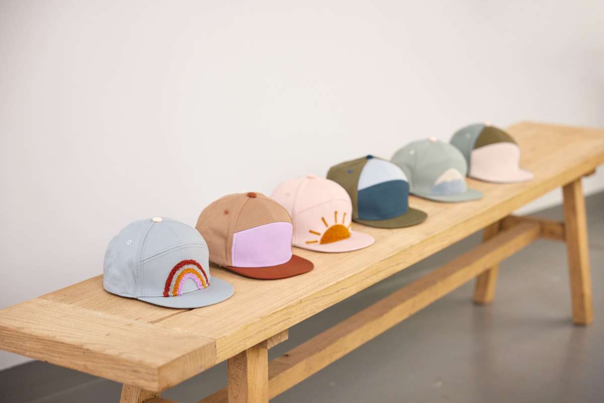 Lässig Skater Cap „Rainbow blue“ auf Holzbank – moderner Kinderstyle im Alltag